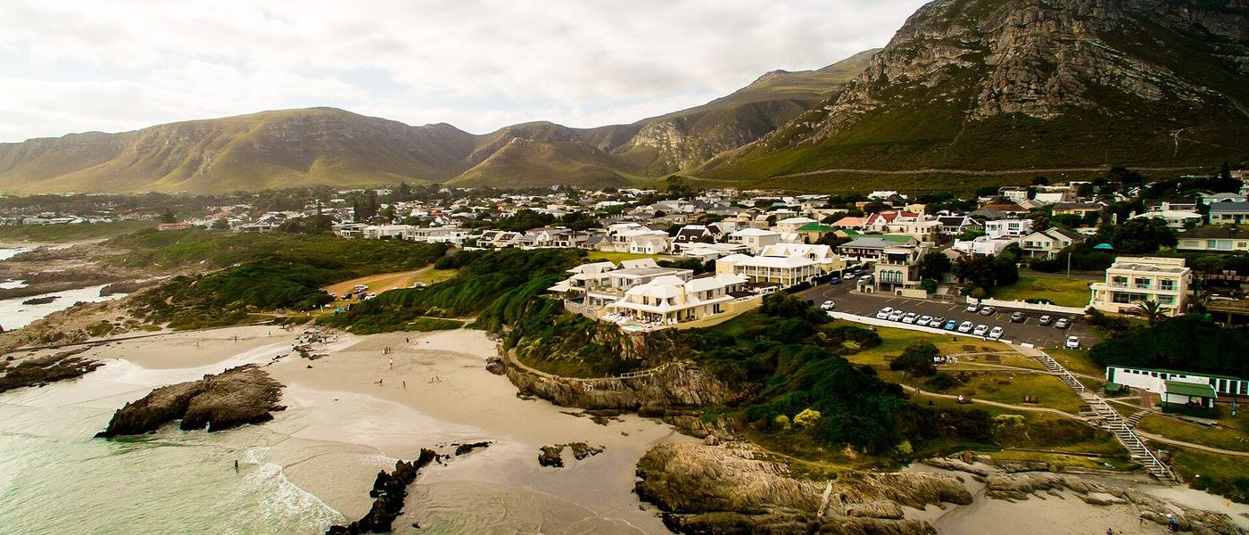 Rugged coastline at Hermanus with the Atlantic Ocean and whales offshore